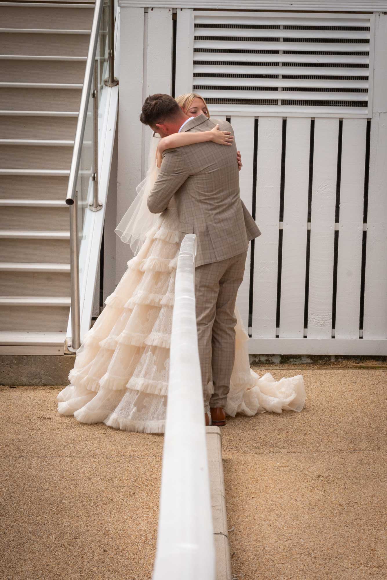 Bride and groom sharing an emotional embrace at St Ives Harbour Hotel with sea backdrop