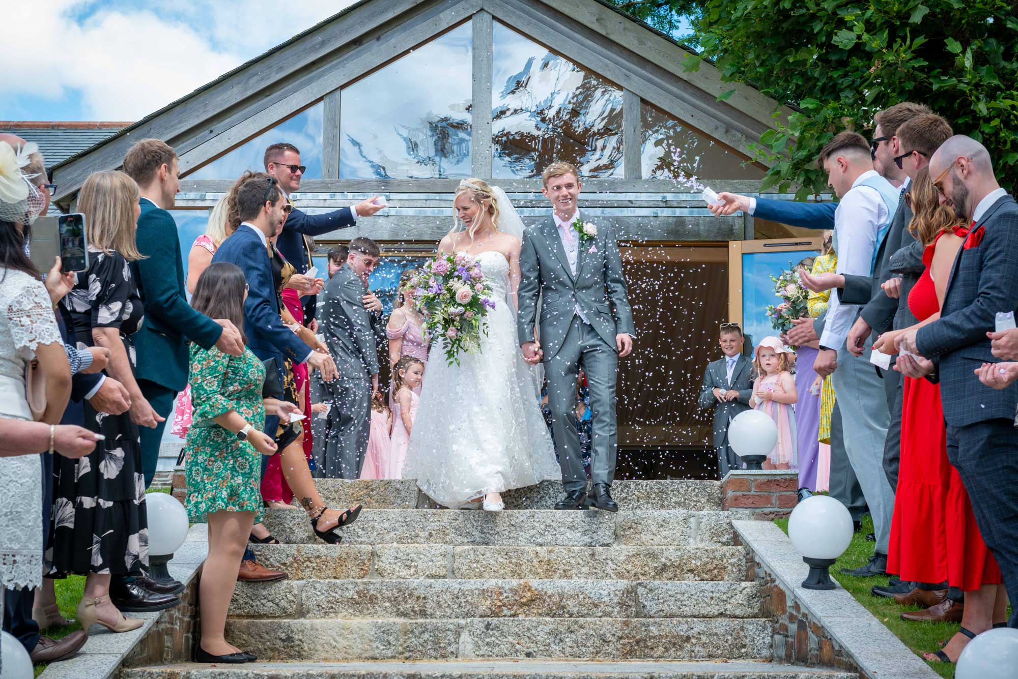 Confetti celebration at Tredudwell Manor - joyful wedding exit